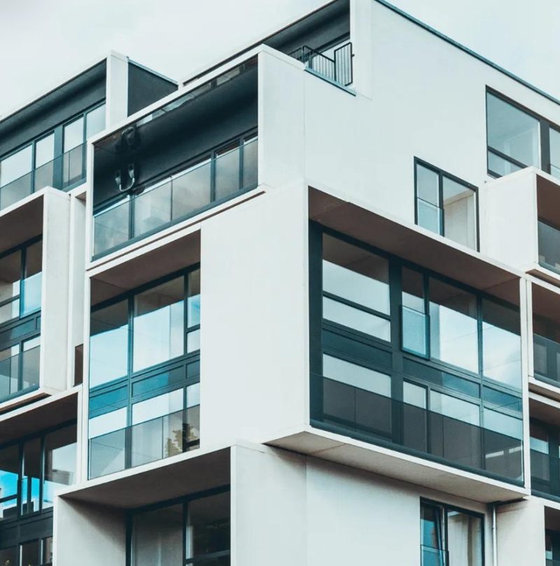 Modern residential building with glass facade and balconies